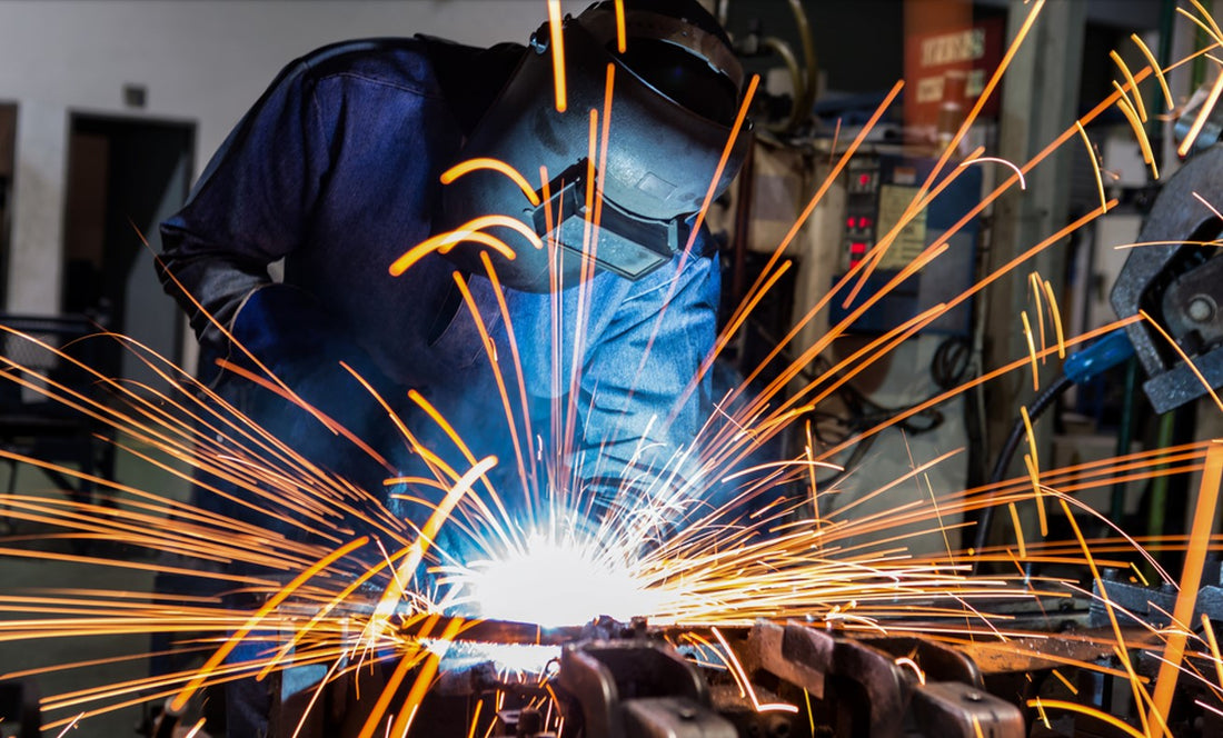 welder using bronze brazing rod in machine shop while wearing PPE