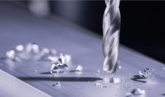 metal drill bit drilling holes in aluminum