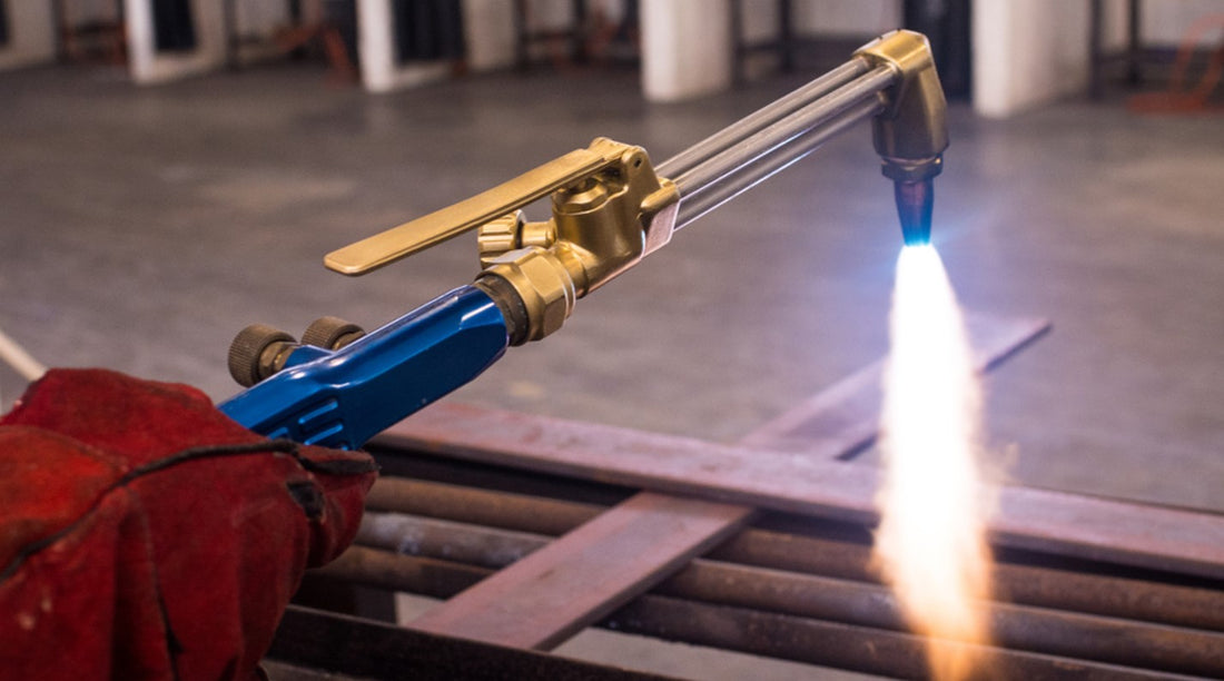 Acetylene gas torch cutting metal