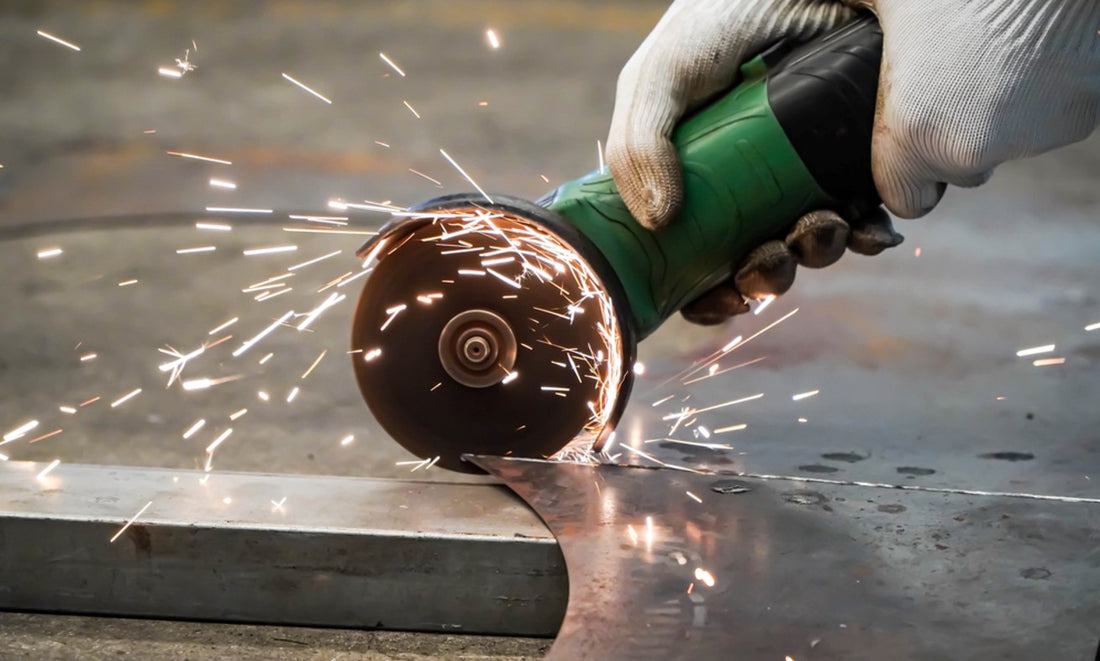 Hands wearing work gloves using a metal grinding wheel