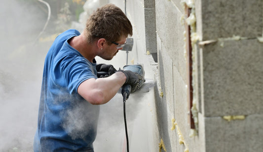 Man using masonry grinding wheel at construction site