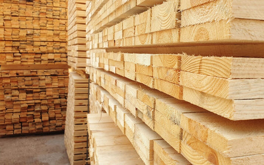 Stacks of raw wood in lumber warehouse 