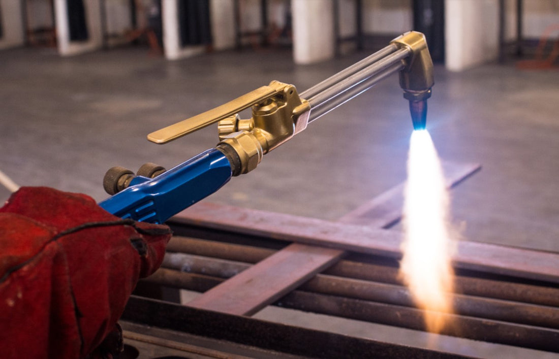 Welder using cutting torch to cut metals
