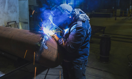 Welder working in machine shop