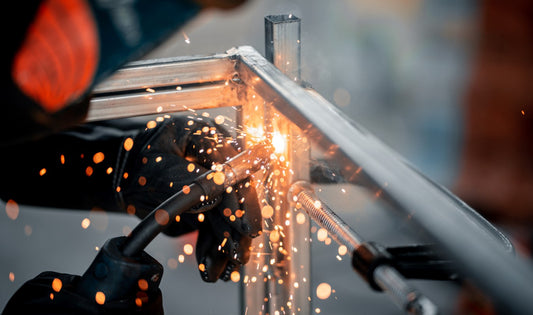 Welding a silver metal rack with MIG welding