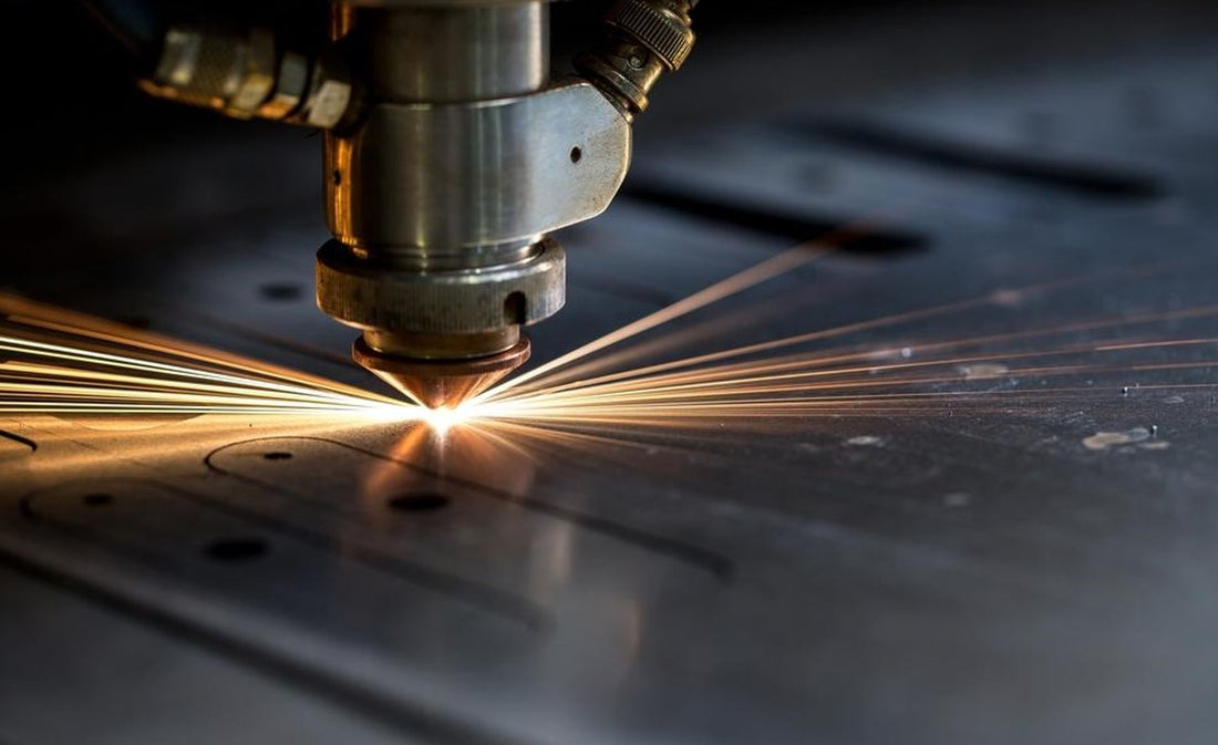 laser cutting piece of metal with sparks flying