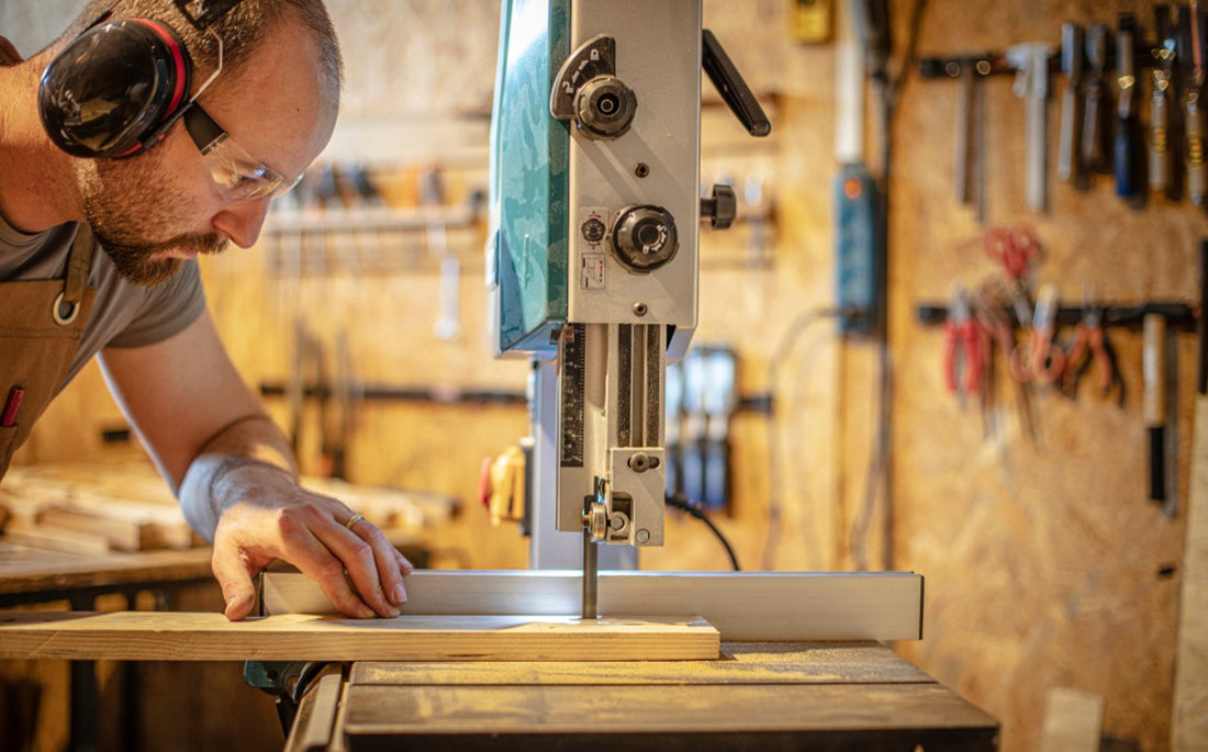 man using a bandsaw blade in a workshop