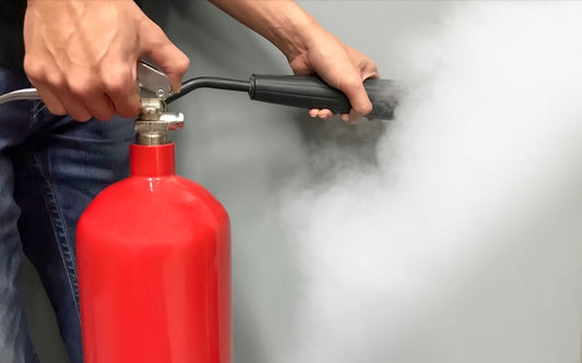 man using fire extinguisher