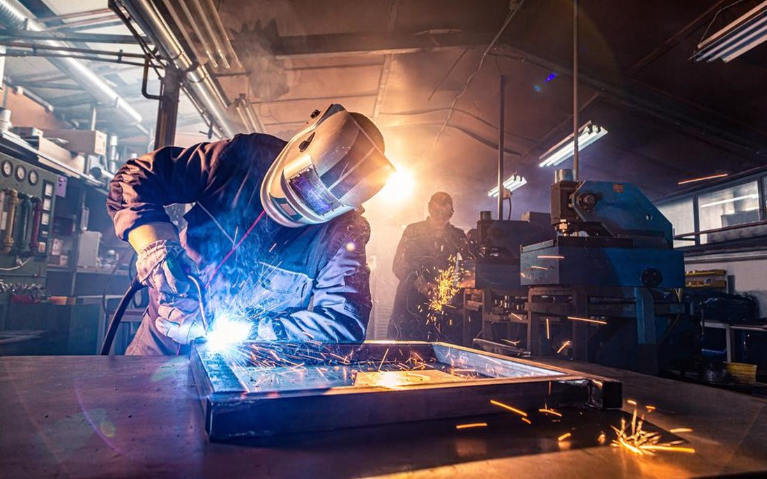 two welders working in machine shop